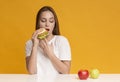 Hungry Girl Eating Unhealthy Burger Instead Of Apple Fruit