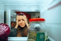 Unhappy Woman looking in the fridge Having nothing to eat Royalty Free Stock Photo