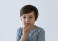 Hungry kid eating chocolate cake, Happy child looking at camera while eating sweet for his snack, Isolated young boy eating Royalty Free Stock Photo