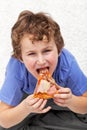 Hungry kid eating pizza Royalty Free Stock Photo