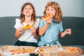 Hungry kids eating pizza. Little girl and boy eat pizza. Royalty Free Stock Photo