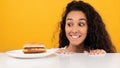 Hungry Lady Looking At Burger Peeping Out Table Royalty Free Stock Photo