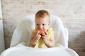 Hungry little baby girl eating apple Royalty Free Stock Photo