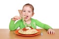 Hungry little girl eating spaghetti