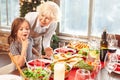 Hungry little girl looking at served dinner table