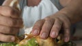 Hungry man eating chicken fast with hands, impoliteness in restaurant, addiction