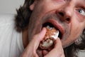 Hungry man eating pastry