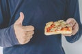 Hungry man eating pizza and showing thumbs up very good on white background Royalty Free Stock Photo