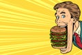 Hungry man with a giant Burger, street food