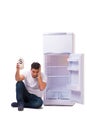 The hungry man looking for money to fill the fridge Royalty Free Stock Photo