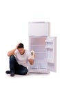 The hungry man looking for money to fill the fridge Royalty Free Stock Photo