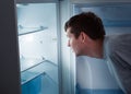 Hungry man looking in refrigerator Royalty Free Stock Photo