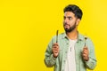 Hungry man waiting for serving dinner meal dishes with restlessness holding cutlery fork knife