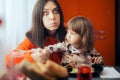 Hungry Mom Trying to Eat While Child Sits on her Lap Royalty Free Stock Photo