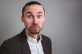 Hungry office worker chewing dessert on gray