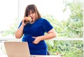 Hungry overweight woman holding hamburger, During work from home, gain weight problem. Concept of binge eating disorder BED