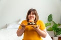 Hungry overweight young asian woman holding hamburger, Her hungry all time and overeat, gluttony and binge eating. Her lifestyle Royalty Free Stock Photo