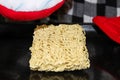 A hungry person about to cook instant noodles on a baking sheet in the oven Royalty Free Stock Photo