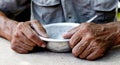 Hungry. Poor old man`s hands an empty bowl. Selective focus. Poverty in retirement. Alms