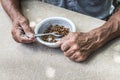 Hungry. Poor old man& x27;s hands an bowl of porridge . Selective focus. Poverty in retirement