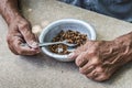 Hungry. Poor old man& x27;s hands an bowl of porridge . Selective focus. Poverty in retirement