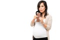 Hungry pregnant woman taking a bite off a chocolate Royalty Free Stock Photo