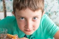 A hungry preteen boy eating chicken nuggets in a restaurant Royalty Free Stock Photo