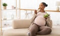 Hungry african american pregnant woman enjoying vegetable salad, copy space Royalty Free Stock Photo