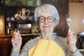 Hungry senior woman holding knife and fork Royalty Free Stock Photo