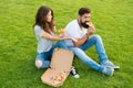 Hungry students sharing food. Pure enjoyment. Couple eating pizza relaxing on green lawn. Fast food delivery. Bearded Royalty Free Stock Photo