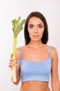 Hungry surprised girl should eat leeks, as she on a diet Royalty Free Stock Photo