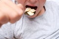 A hungry teen teenager boy eating dumplings close up at home, convenience and rapid cooking food concept