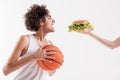 Hungry thin young man holding ball