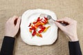 Hungry woman eating red hot chili peppers. Symbol of adapting to Royalty Free Stock Photo