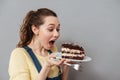 Hungry young pregnant woman going to eat chocolate cake Royalty Free Stock Photo