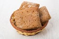 Hunks of rye bread in wicker basket on table Royalty Free Stock Photo
