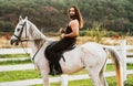 Hunky cowboy. Young muscular guy in t-shirt on horseback. Man riding a horse. Hunky cowboy rides horse. Country life