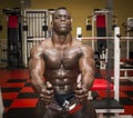 Hunky muscular black bodybuilder working out in