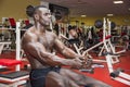 Hunky muscular black bodybuilder working out in