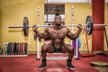 Hunky muscular black bodybuilder working out in