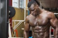 Hunky muscular black bodybuilder working out in