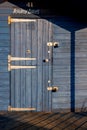 Padlocked door of beach hut bathed in evening sunlight at Hunstanton Norfolk on June 2, 2010