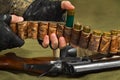 Hunter adds ammunition for the shotgun in the bandolier