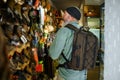 Hunter with backpack at the showcase in gun store Royalty Free Stock Photo