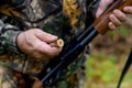 Hunter charges a cartridge into the chamber of a rifle close up Royalty Free Stock Photo