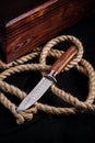 Hunter combat hand made knife and hemp rope. The blade has a beautiful damask pattern, beautiful handmade hunting knife Royalty Free Stock Photo