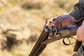 Hunter equips the retro double-barreled shotgun with cartridges, close up. Hunting season