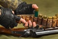 Hunter fills a bandoleer of ammunition for the shotgun Royalty Free Stock Photo