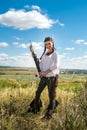 hunter girl shooting bow and arrow in the grassland Royalty Free Stock Photo