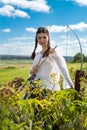 hunter girl shooting bow and arrow in the grassland Royalty Free Stock Photo